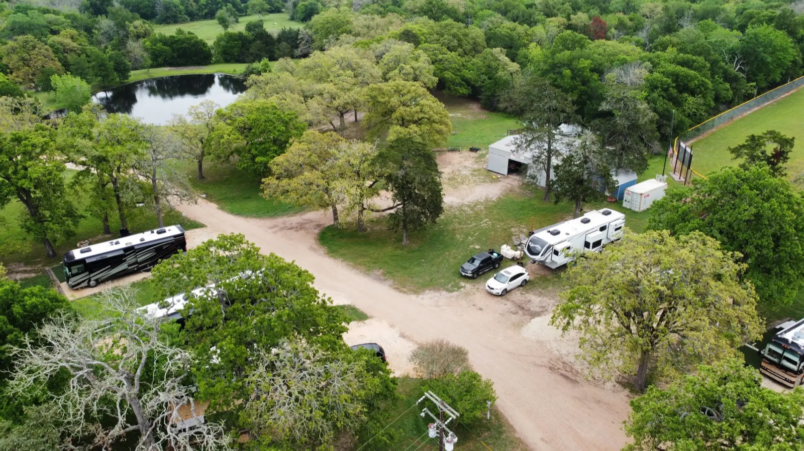 Aerial of the RV sites among the live oaks, with the pond beyond