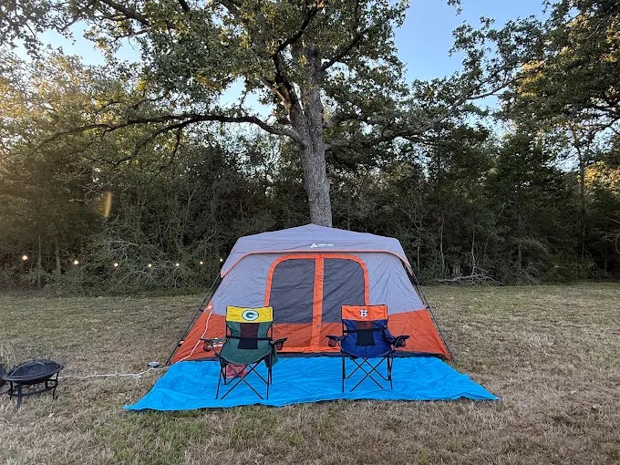 Tent camping under the oaks with a fire pit